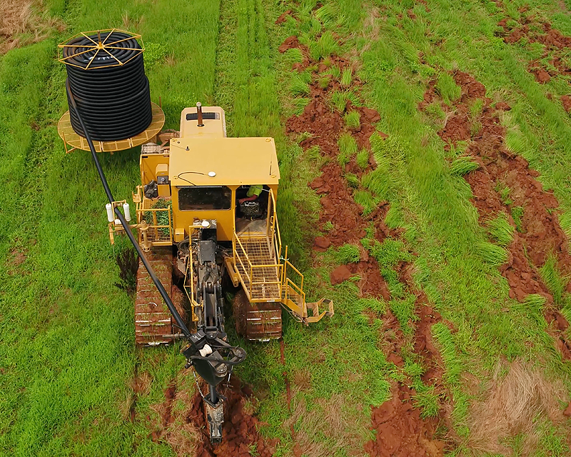 an excavator installing an irrigation system